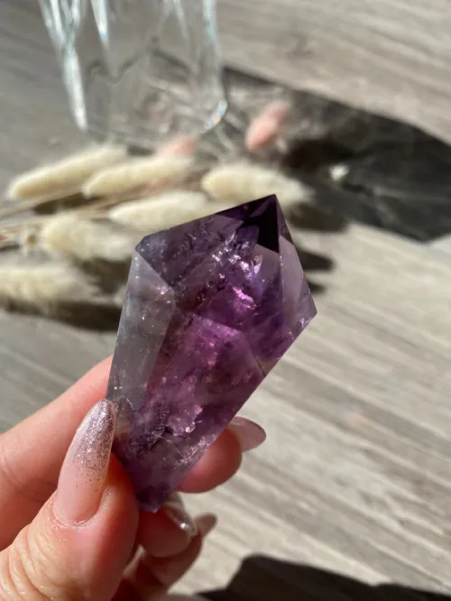 Amethyst jewelry pieces showing color variations in different lighting conditions