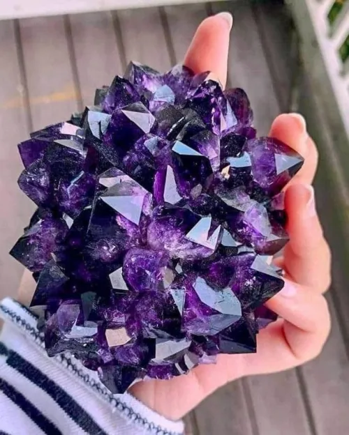 Essential crafting tools for amethyst projects including jewelry pliers, wire cutters, spools of copper and silver wire, and epoxy adhesive on a wooden table.